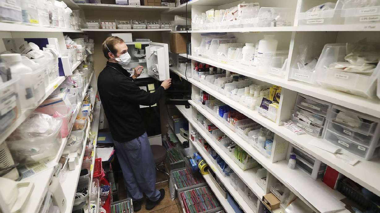 Hope Clinic physician assistant Matt Pierce gathers
medications at the clinic in Midvale on Wednesday, Jan. 6, 2021.
Two bills to be considered by the Utah Legislature would broaden
the role of physician assistants to let them offer mental health
therapy and respond during a health emergency.