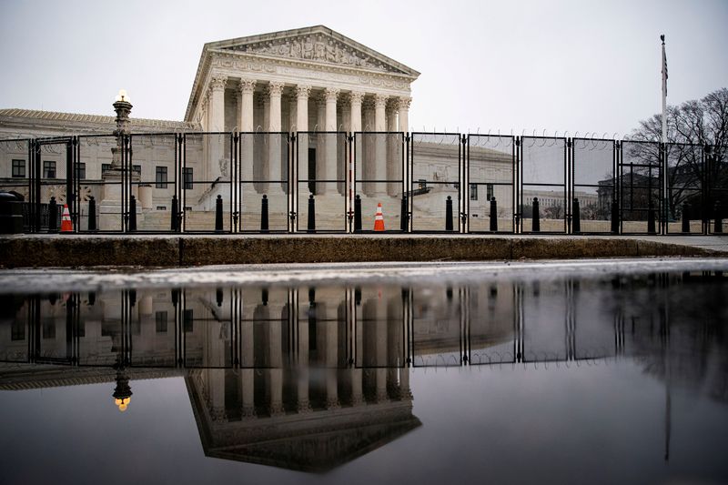 FILE PHOTO: Barbed wire and security fencing surrounds the U.S. Supreme Court in Washington, U.S., January 26, 2021. REUTERS/Al Drago/File Photo