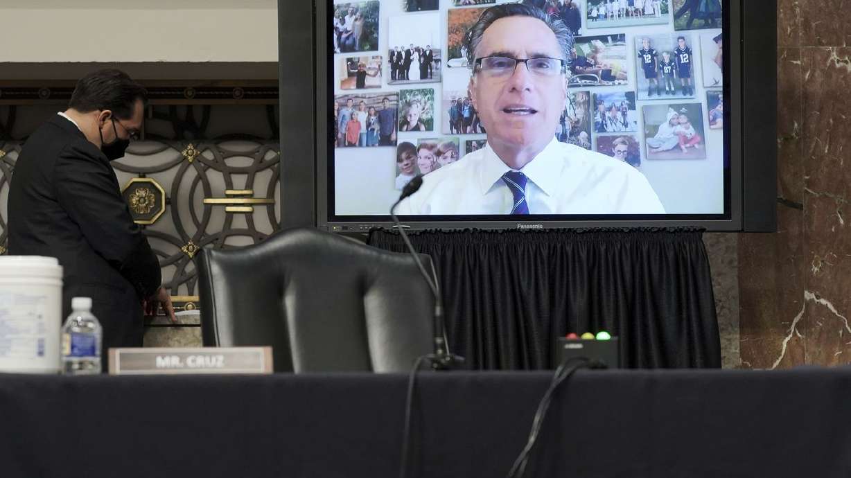 Sen. Mitt Romney, R-Utah, appears remotely as he speaks
during a confirmation hearing for United States Ambassador to the
United Nations nominee Linda Thomas-Greenfield before the Senate
Foreign Relations Committee on Capitol Hill, Wednesday, Jan. 27,
2021, in Washington. Photos of his grandchildren are seen behind
him.