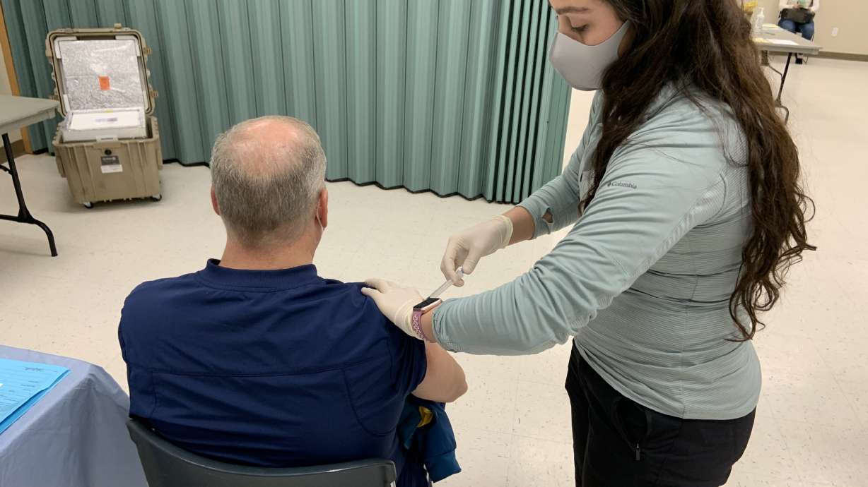 Mary Gallen, RN, gives a second dose of the COVID-19 vaccine to a Tooele County resident.
