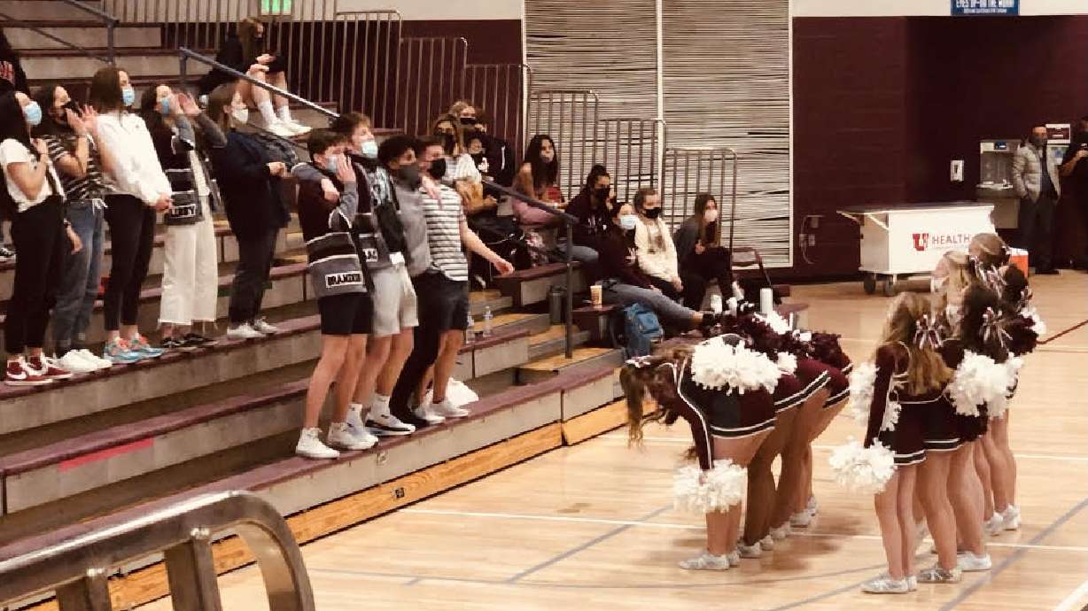 Cheerleaders and students at a recent Jordan High School basketball game show their school spirit.