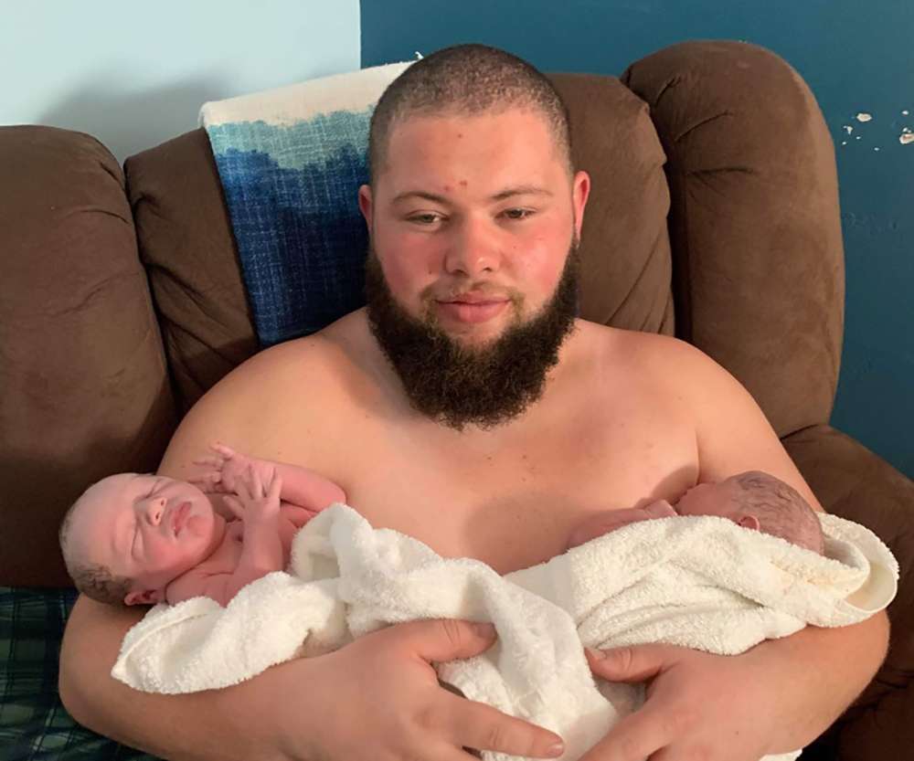 Marcus Clay holds his sons, Emmanuel Azariah Clay and Elijah Abel Clay.