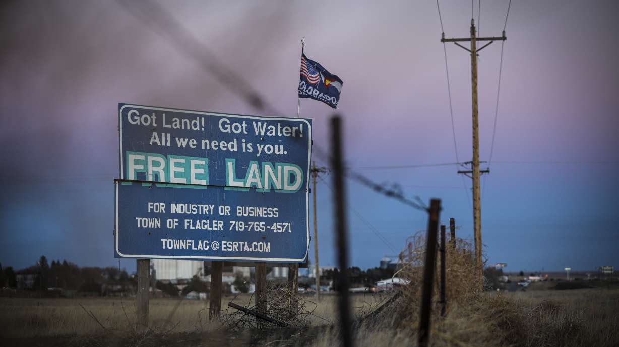 A billboards promoting “Free Land” off of I-70 greet passing motorists in Flagler, Colorado, on Friday Dec. 4, 2020. Flagler is a rarity in the West — it’s offering land without a price tag to someone willing to stake a future in the town and open a business that will provide a much needed infusion of jobs in the small Colorado Plains town of 620 people. Flagler is near Exit 395 on I-70 and about 120 miles east of Denver.