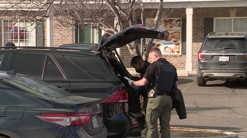 Police officers search a vehicle outside of Rainbow Massage in Orem on Thursday, Feb. 4, 2021. At least six people were arrested Thursday following an investigation into several massage parlors in Utah County that police say were fronts for human
trafficking and prostitution.