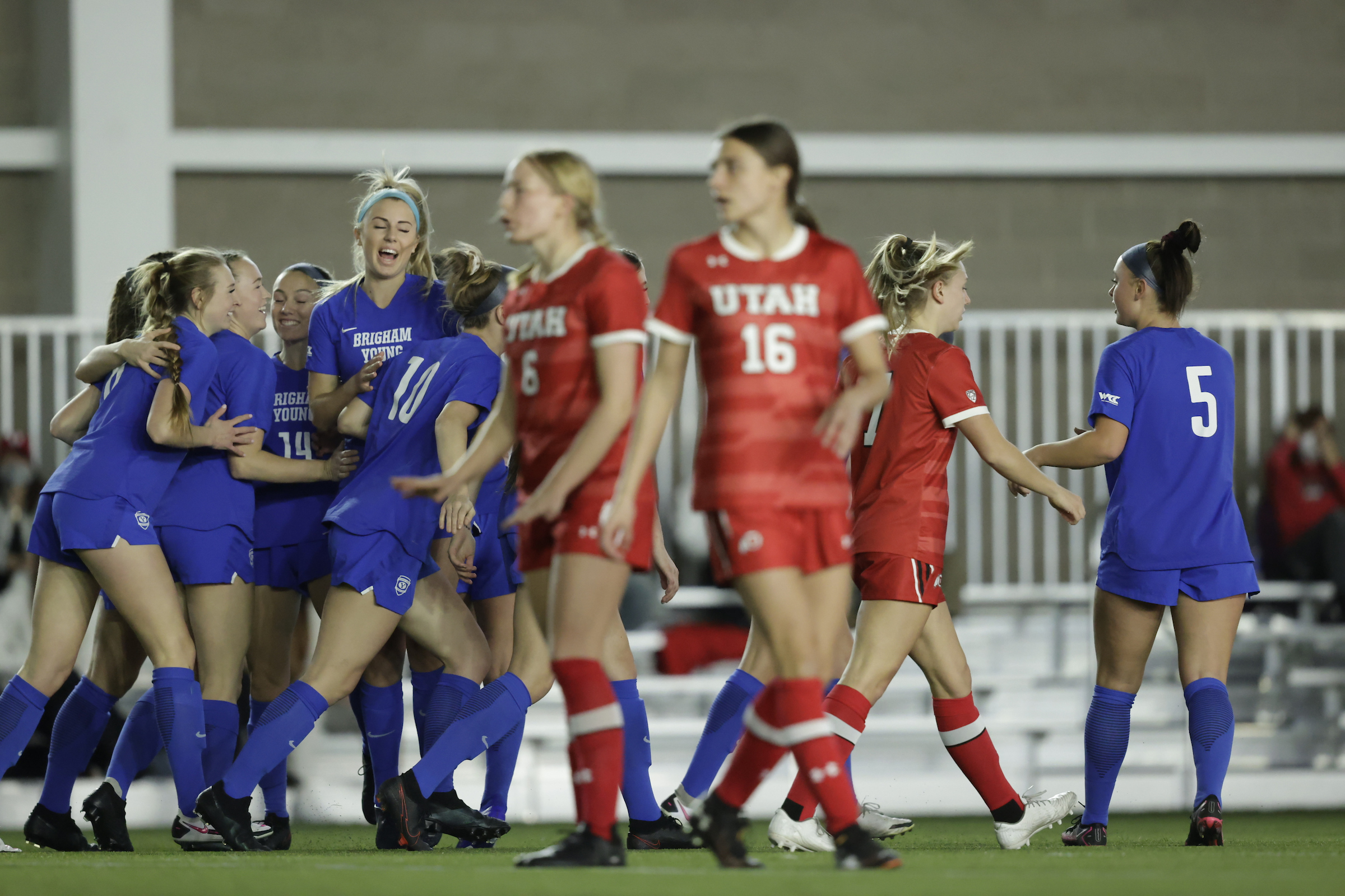 BYU's Cameron Tucker, center, celebrates her first goal with her teammates during the Cougars' season opener Saturday, Feb. 6, 2021 at the RSL indoor training facility in Herriman.