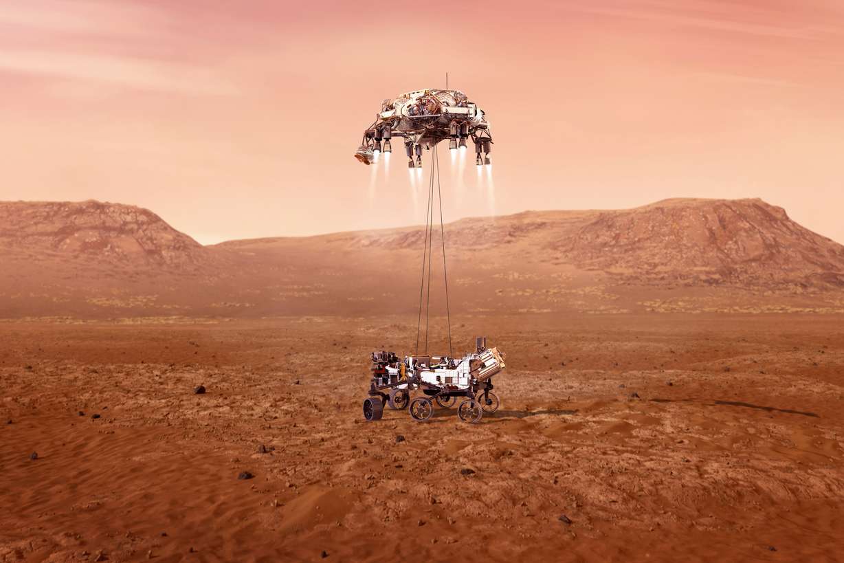 This illustration provided by NASA shows the Perseverance rover, bottom, landing on Mars. Hundreds of critical events must execute perfectly and exactly on time for the rover to land safely on Feb. 18, 2021.