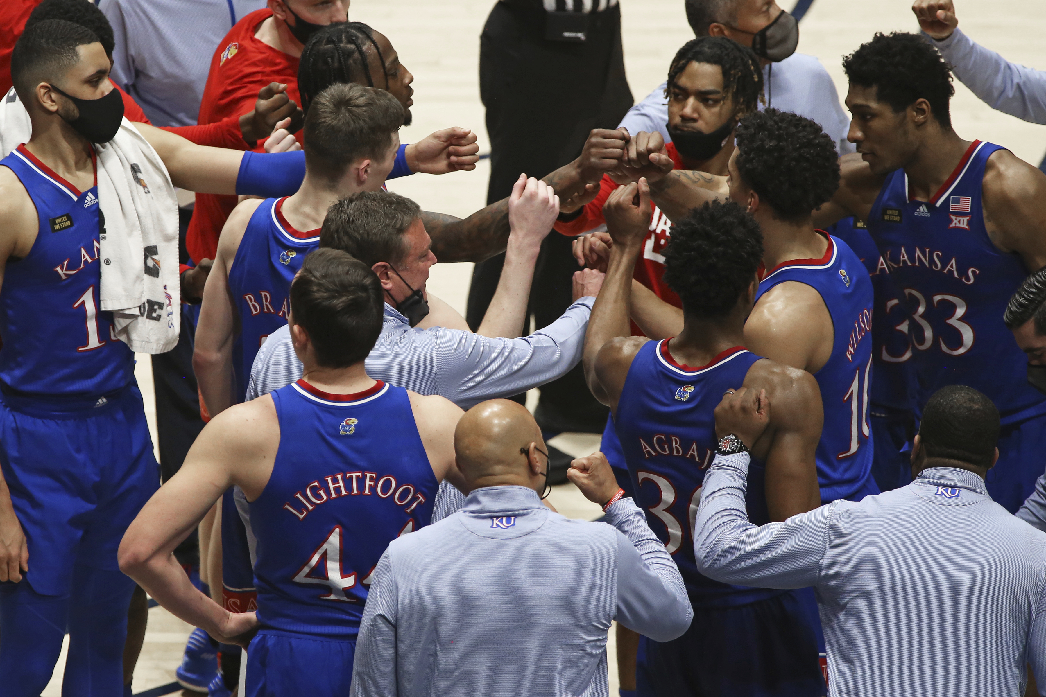 Kansas coach Bill Self meets with players during the second half of an NCAA college basketball game against West Virginia, Saturday, Feb. 6, 2021, in Morgantown, W.Va.