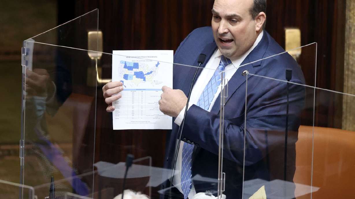 Rep. Walt Brooks, R-St. George, holds a map of states
that don’t require a permit to carry a concealed firearm as the
House discusses his bill, HB60, at the Capitol in Salt Lake City on
Tuesday, Jan. 26, 2021.