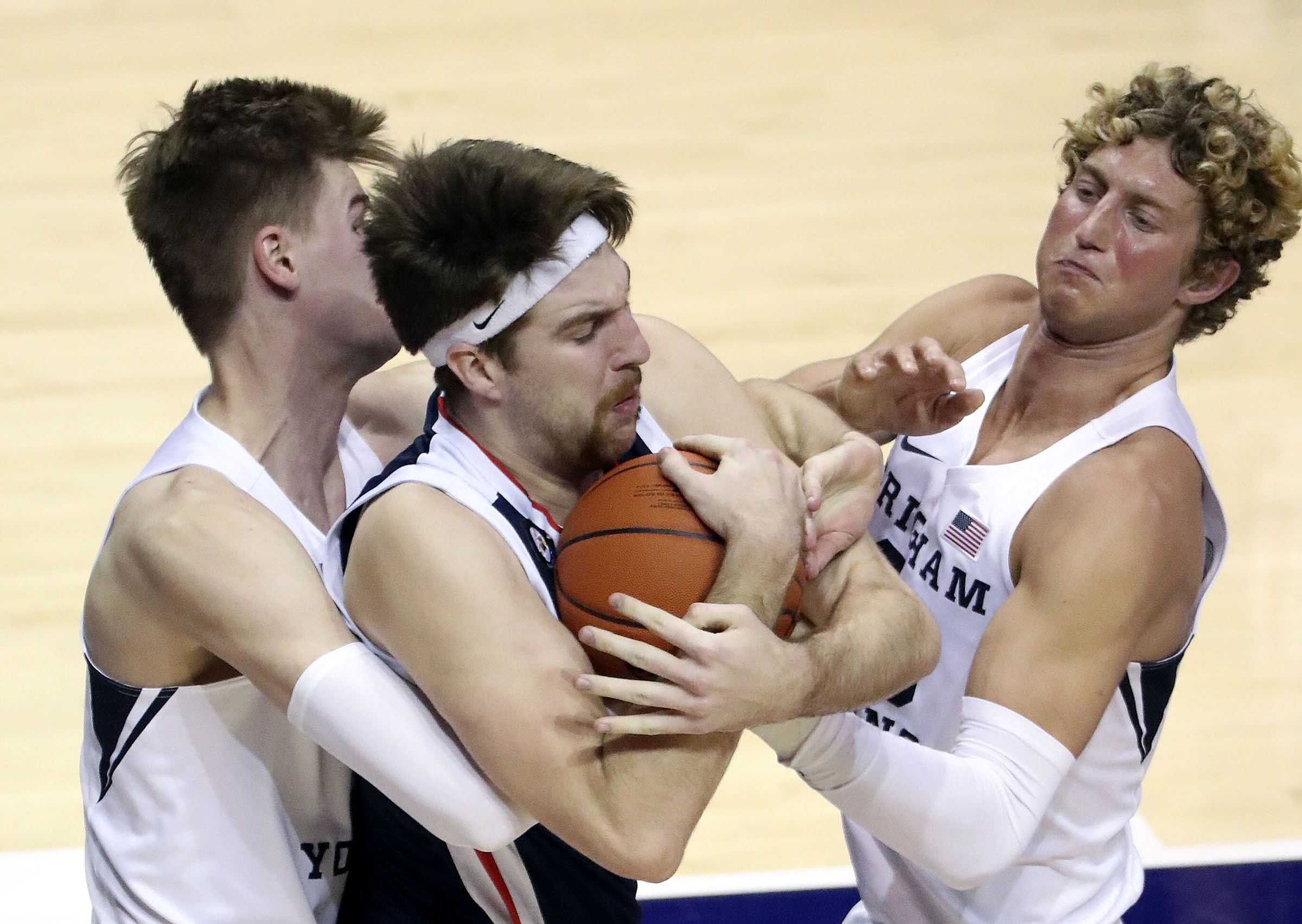 Brigham Young Cougars forward Matt Haarms (3), Gonzaga Bulldogs forward Drew Timme (2) and Brigham Young Cougars forward Caleb Lohner (33) fight for the ball during a basketball game at the Marriott Center in Provo on Monday, Feb. 8, 2021.
