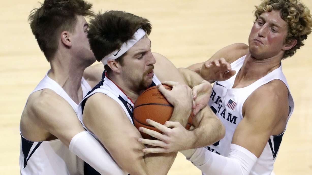 Brigham Young Cougars forward Matt Haarms (3), Gonzaga Bulldogs forward Drew Timme (2) and Brigham Young Cougars forward Caleb Lohner (33) fight for the ball during a basketball game at the Marriott Center in Provo on Monday, Feb. 8, 2021.