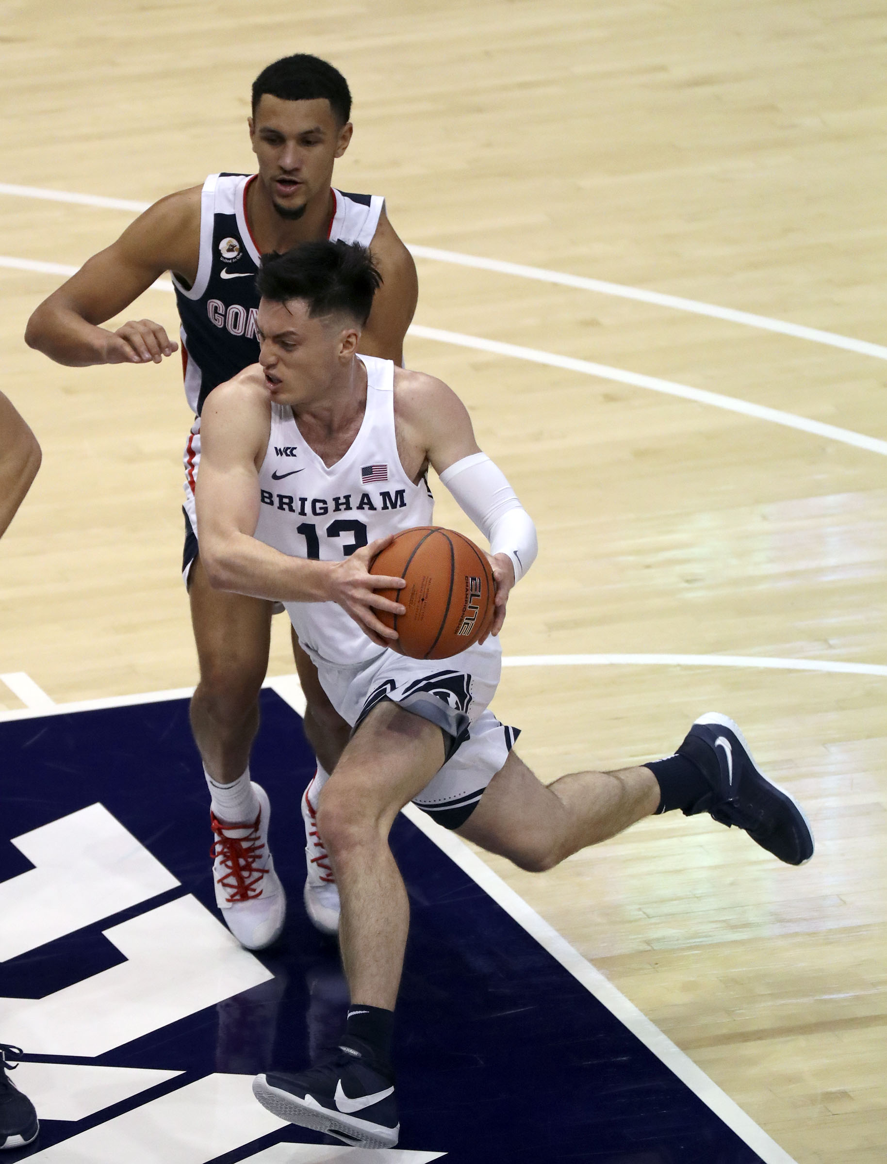 BYU guard Alex Barcello (13) dribbles around Gonzaga guard Jalen Suggs (1) during a basketball game at the Marriott Center in Provo on Monday, Feb. 8, 2021. BYU lost 71-82.