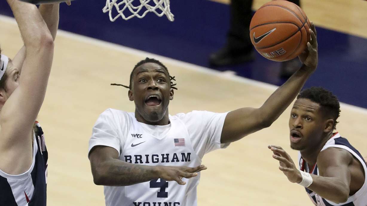 Brigham Young Cougars guard Brandon Averette (4) shoots as Gonzaga Bulldogs guard Joel Ayayi (11) watches during a basketball game at the Marriott Center in Provo on Monday, Feb. 8, 2021. BYU lost 71-82.