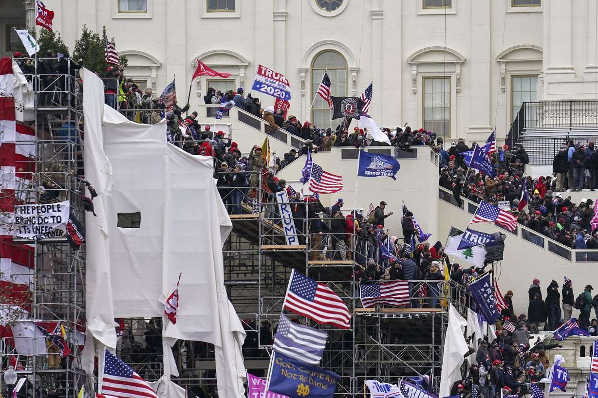 In this Jan. 6, 2021, file photo rioters loyal to President Donald Trump storm the U.S. Capitol in Washington. Arguments begin Tuesday, Feb. 9, in the impeachment trial of Donald Trump on allegations that he incited the violent mob that stormed the U.S. Capitol on Jan. 6.