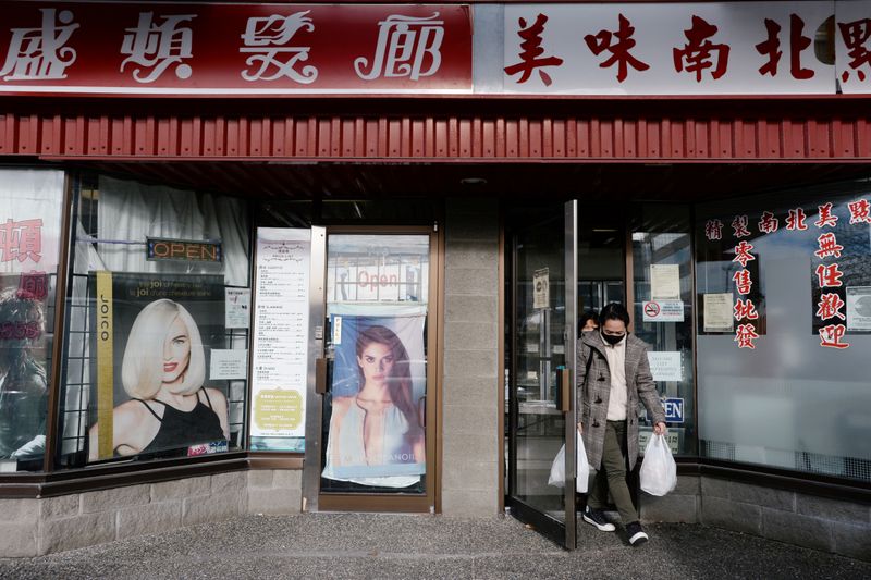 A customer exits Delicious Dim Sum, next door to the Hong Kong Washington Salon in Richmond, British Columbia, Canada January 26, 2021. Picture taken January 26, 2021.  REUTERS/Jennifer Gauthier