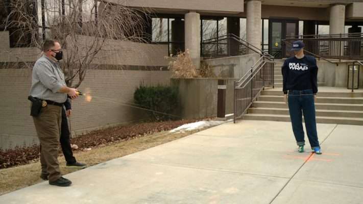 The Bola Wrap is fired at a mannequin and some officers during a demonstration Tuesday, Feb. 9, 2021.