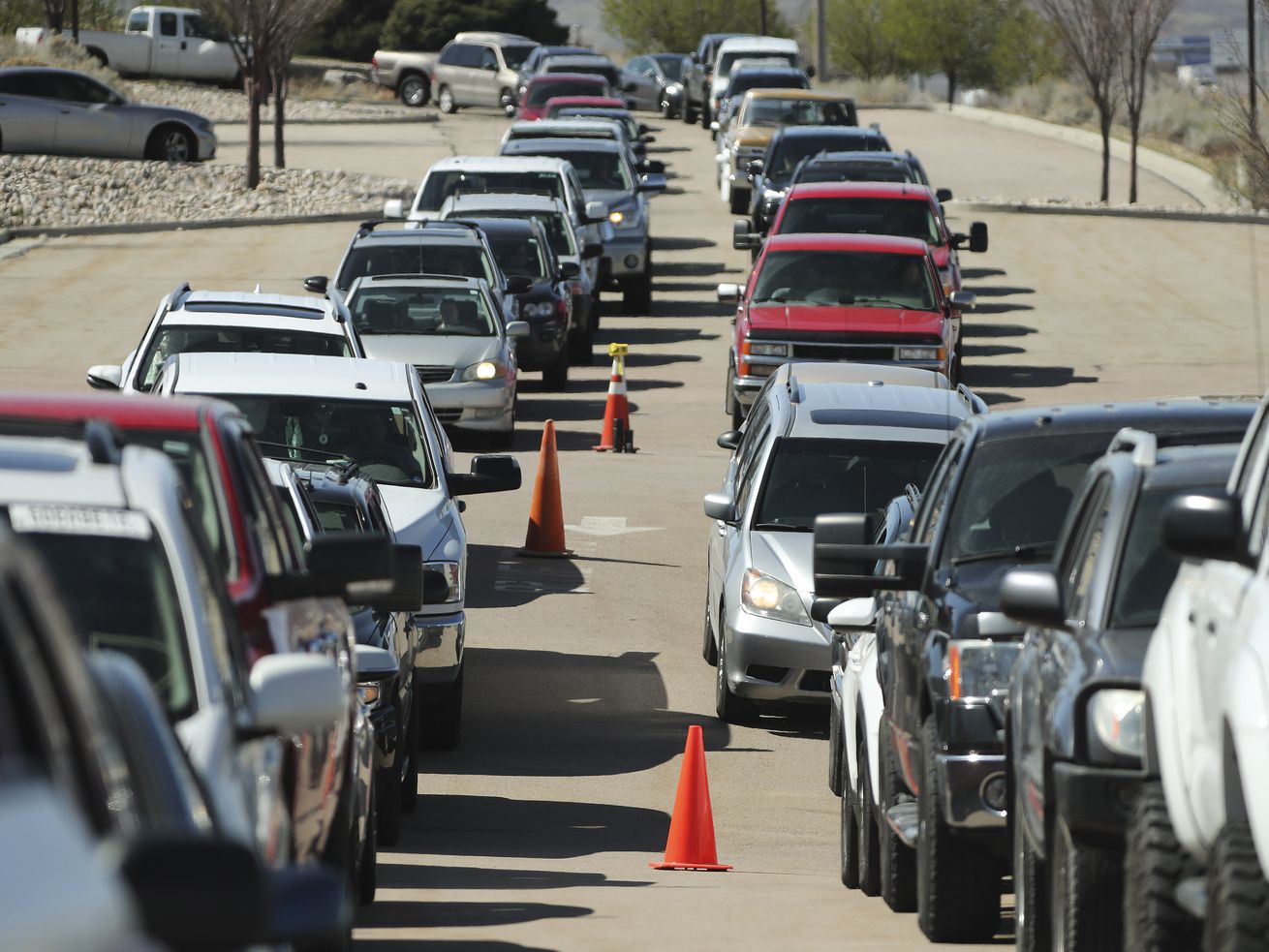 Hundreds of cars wait in line at the Division of
Motor Vehicles drive-thru window in Draper on Friday, April 3,
2020. Some waited in line for hours.