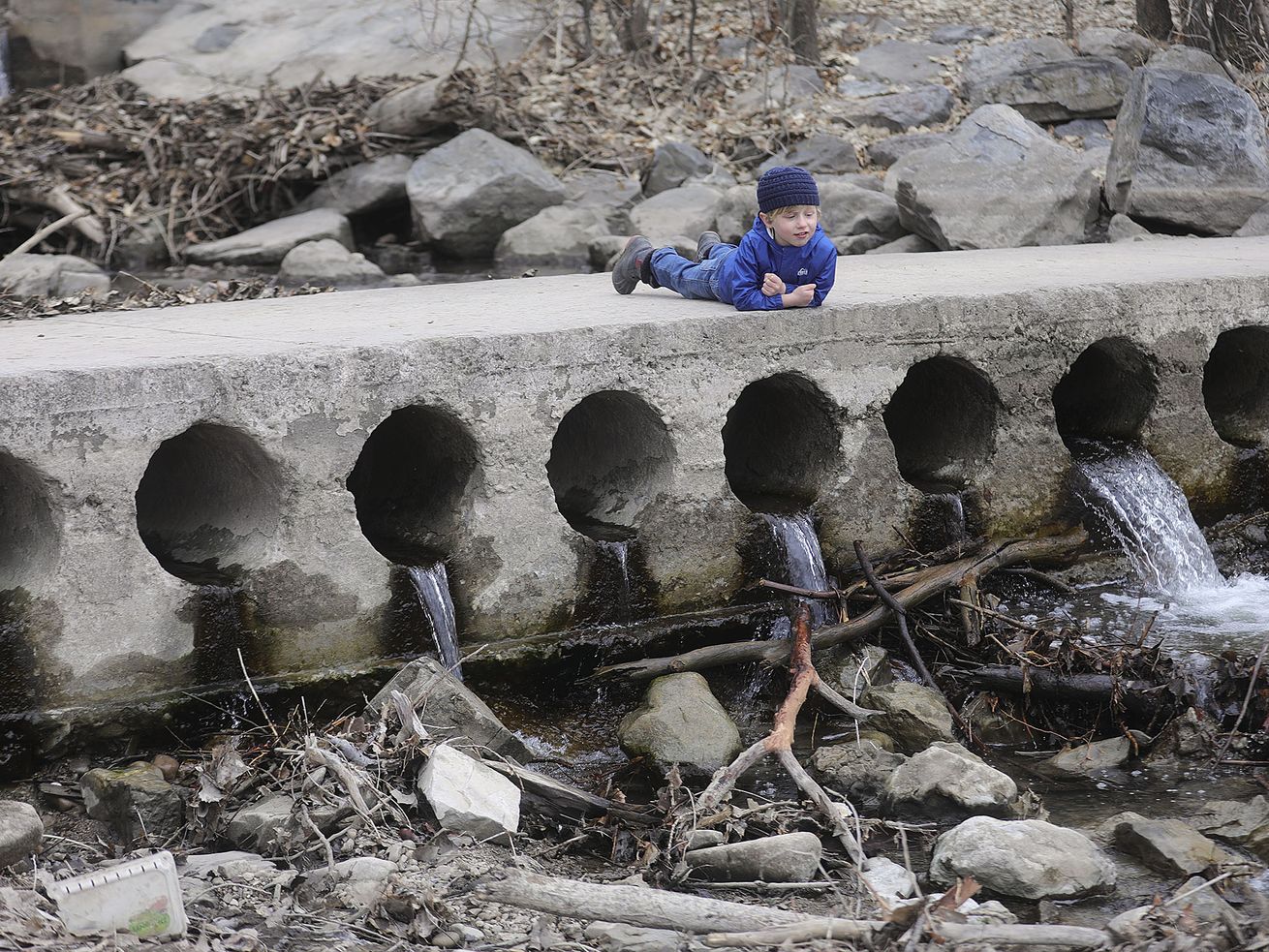 Henry Hovey, 4, watches as water from Parleys Creek as
it flows into the pond at Sugar House Park in Salt Lake City on
Tuesday, Feb. 9, 2021. With a shallow snowpack, water runoff is
expected to be less than normal this year.