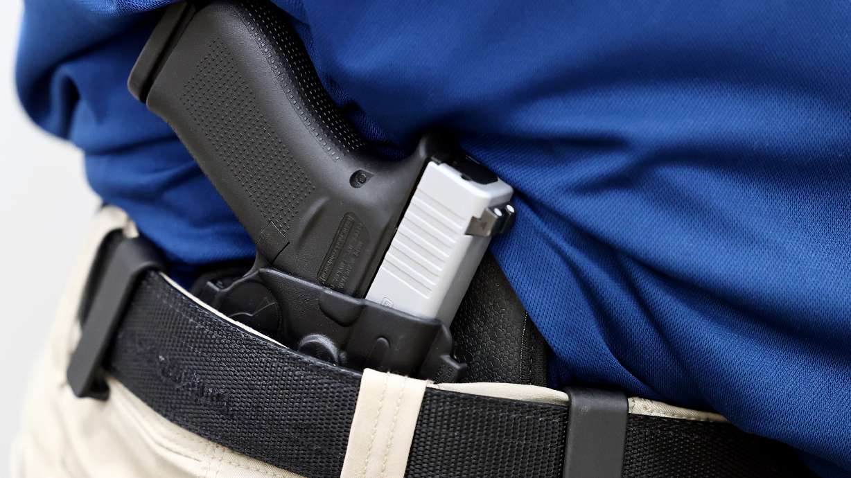 Concealed firearms instructor Aaron Turner shows off his Glock 43X handgun in his inside-the-waistband carry holster as he poses for photos at Legacy Shooting Center in West Jordan on Friday, Feb. 5, 2021. The Utah Legislature is looking to do away with the concealed carry permit requirement.
