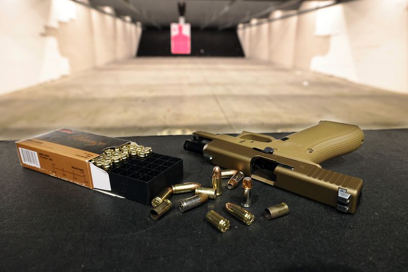 A Glock 19X handgun and ammunition owned by Aaron
Turner, a concealed firearms instructor, sit on the shooting bench
as Turner poses for photos at Legacy Shooting Center in West Jordan
on Friday, Feb. 5, 2021. The Utah Legislature is looking to do away
with the concealed carry permit requirement.