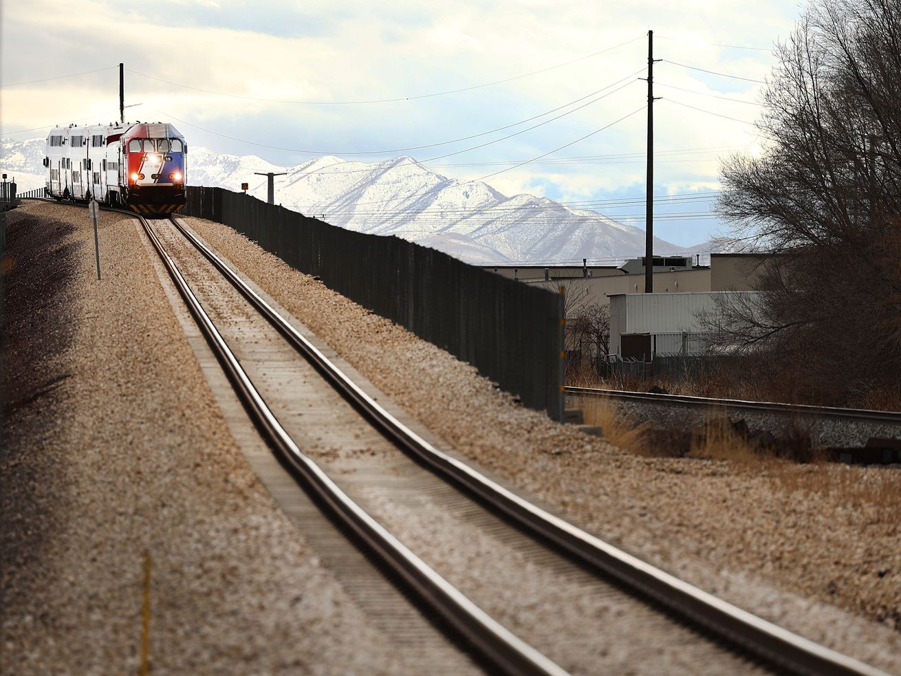 A northbound Frontrunner train comes down a bridge at
9400 South in Sandy on Friday, Feb. 12, 2021. Double-tracking
FrontRunner is one of the infrastructure projects being considered
in the Legislature’s budget talks.