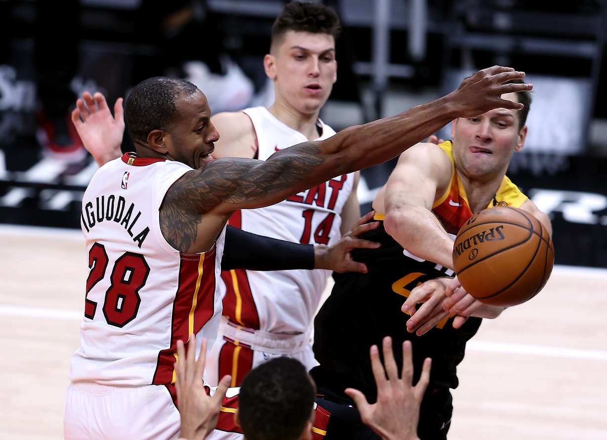 Utah Jazz forward Bojan Bogdanovic (44) tries to pass the ball to Utah Jazz center Rudy Gobert (27) but loses it out of bounds as he is defended by Miami Heat forward Andre Iguodala (28) as the Utah Jazz and the Miami Heat play an NBA basketball game at Vivint Smart Home Arena in Salt Lake City on Saturday, Feb. 13, 2021. Utah won 112-94.