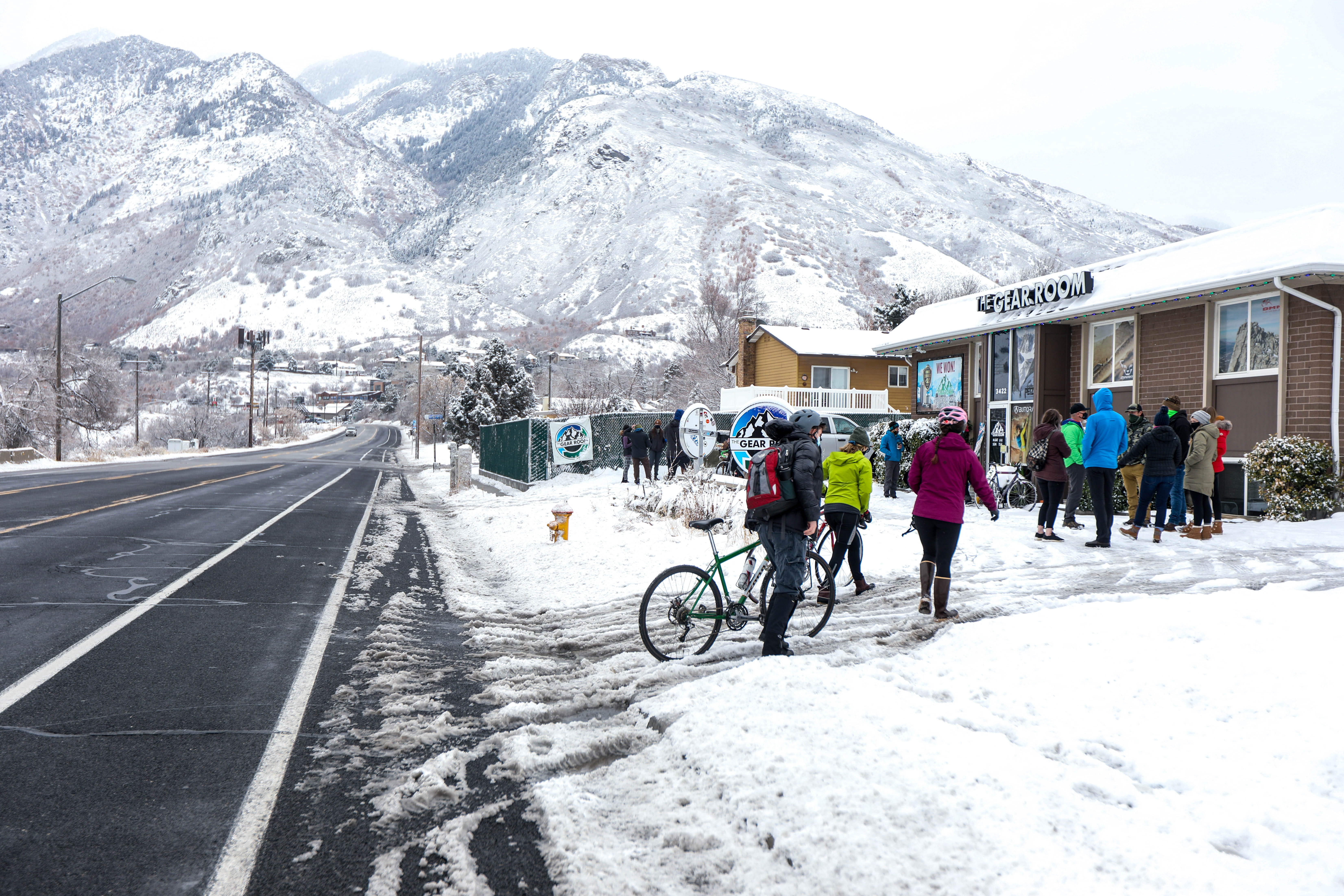 Friends, family, and the public gather to remember Tom Steinbrecher and Louis Holian, at the Gear Room in Cottonwood Heights on Feb. 14, following a snowstorm. The two skiers died in an avalanche recently in Millcreek Canyon.