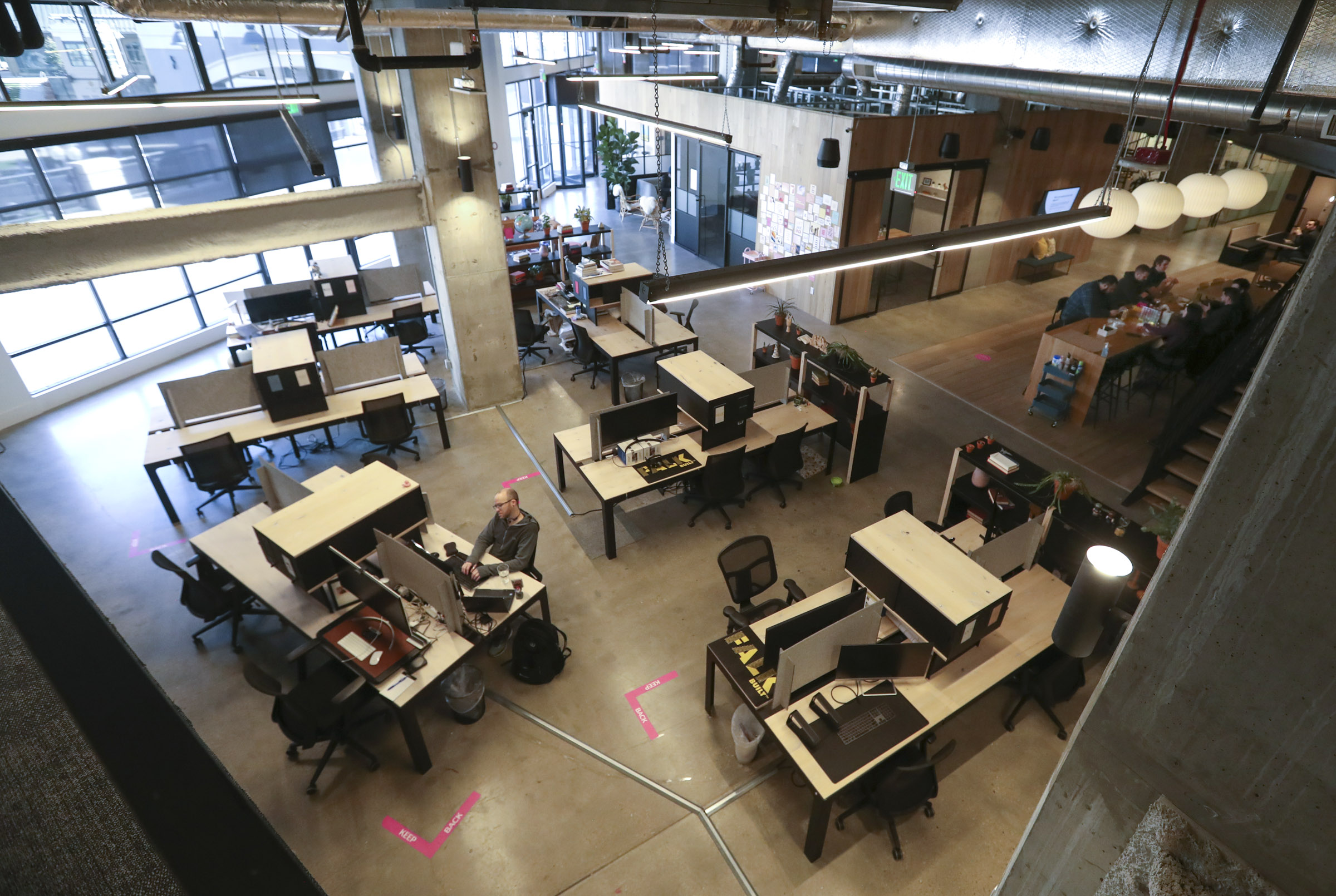 Clients eat lunch and work in their spaces at Kiln, a co-working community at The Gateway in Salt Lake City, on Feb. 8. President Joe Biden announced a new initiative that would have businesses with more than 100 employees require vaccination against COVID-19 or regular testing.