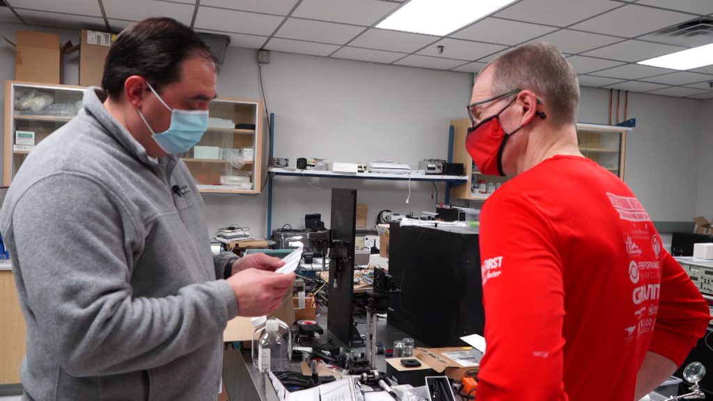 KSL Investigator Matt Gephardt and University of Utah electrical engineer Steve Blair review the directions for a UV light wand bought online.