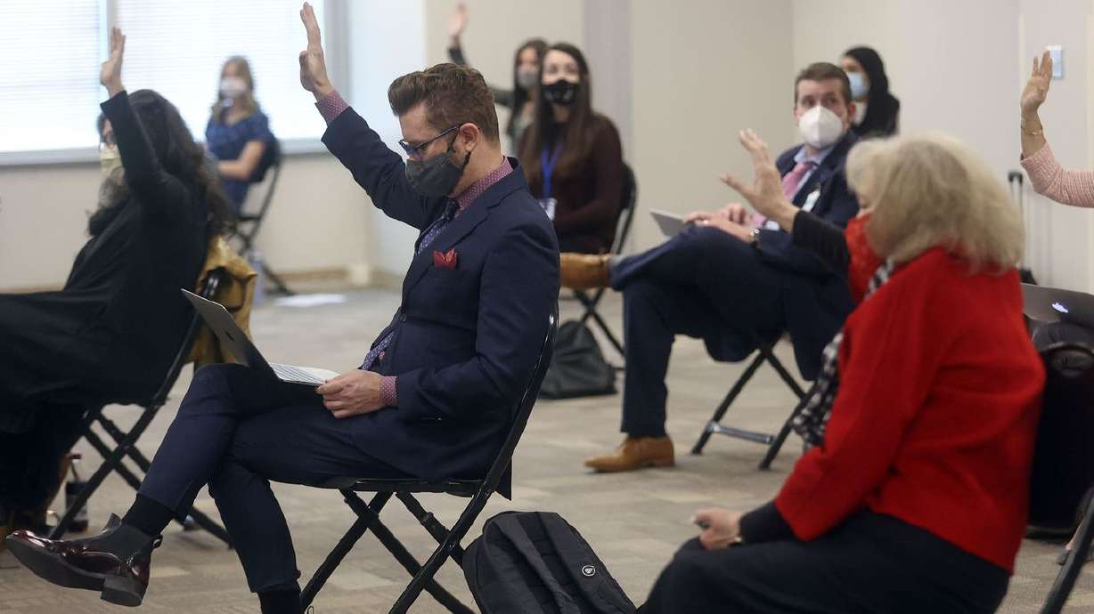 Members of the public who want to speak in opposition
to HB302 raise their hands during a House Education Committee
meeting at the State Office Building in Salt Lake City on Thursday,
Feb. 11, 2021. The bill would bar transgender athletes at
public schools to participate in girls sports.