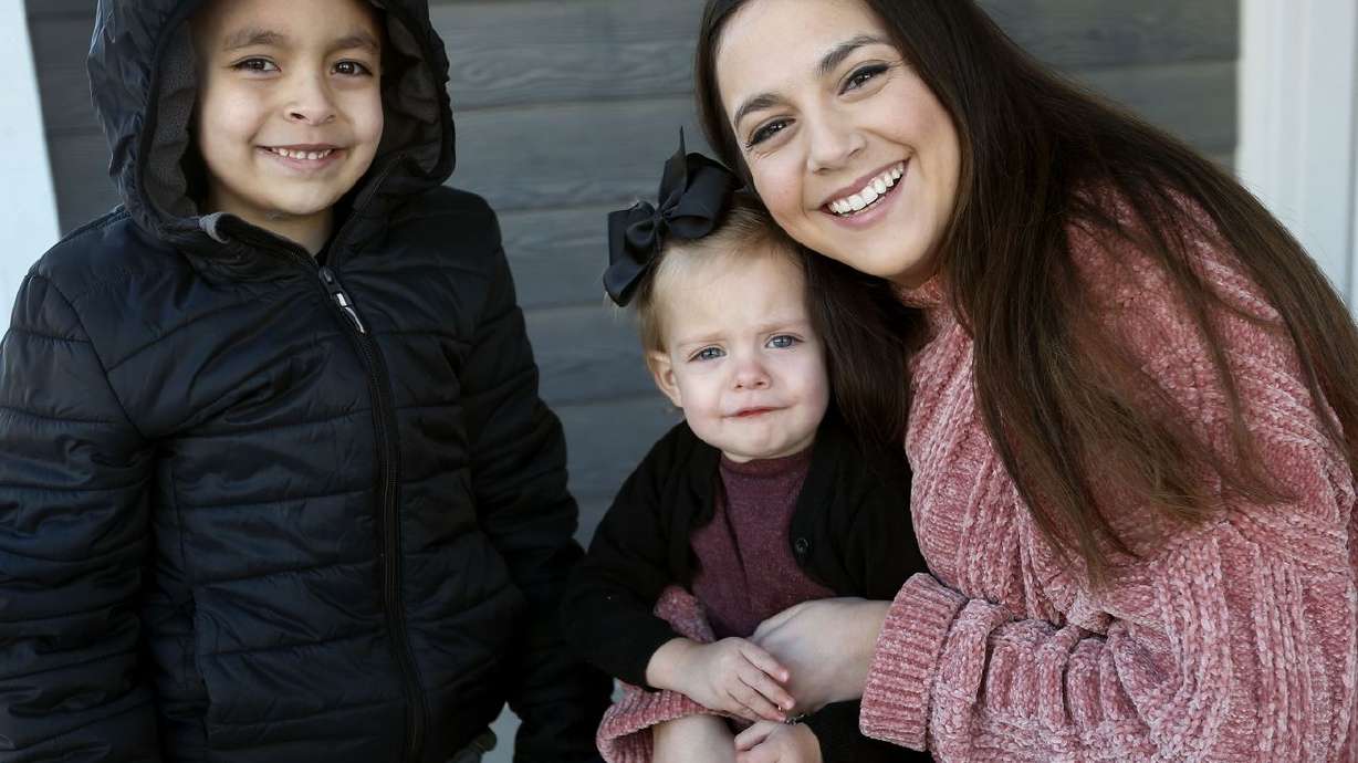 Evi Figgat, right, is photographed with daughter Elinor
and son Oliver at their Eagle Mountain home on Wednesday, Feb. 17,
2021.