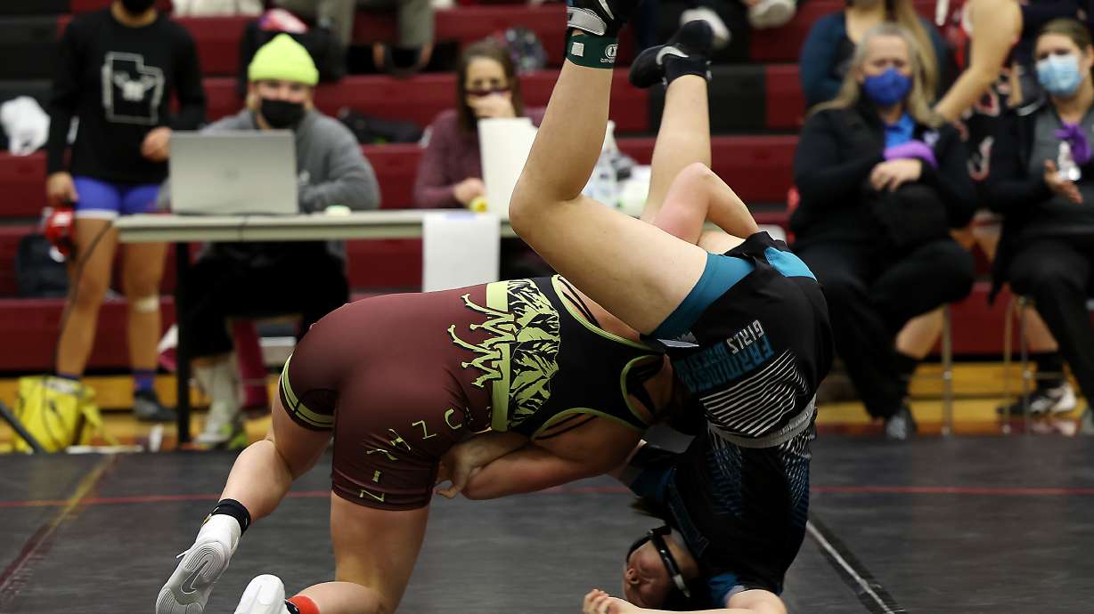 Abigail Archibald of Maple Mountain tosses Jessica Hacking of Farmington as they wrestle in class 150 as 5A/3A/2A/1A girls wrestle for the State Championship at Mountain View High School in Orem on Wednesday, Feb. 17, 2021.