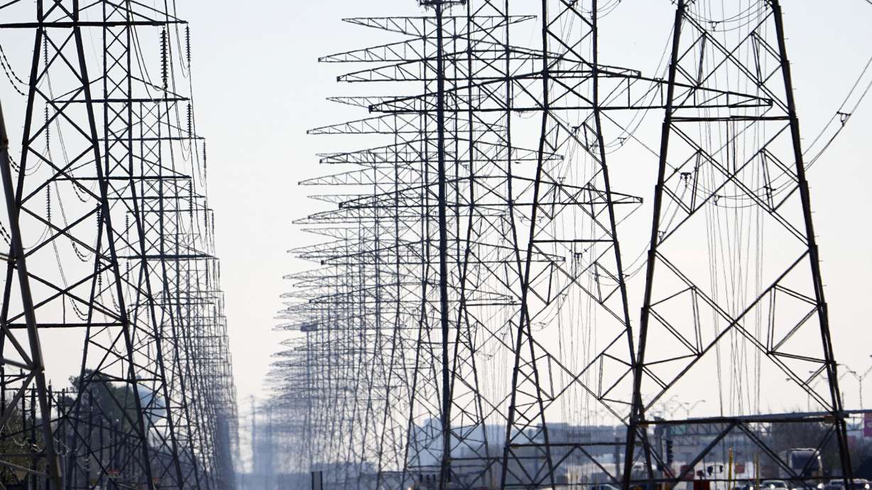 Power lines are shown Tuesday, Feb. 16, 2021, in Houston. More than 4 million people in Texas still had no power a full day after historic snowfall and single-digit temperatures created a surge of demand for electricity to warm up homes unaccustomed to such extreme lows, buckling the state's power grid and causing widespread blackouts. (AP Photo/David J. Phillip)