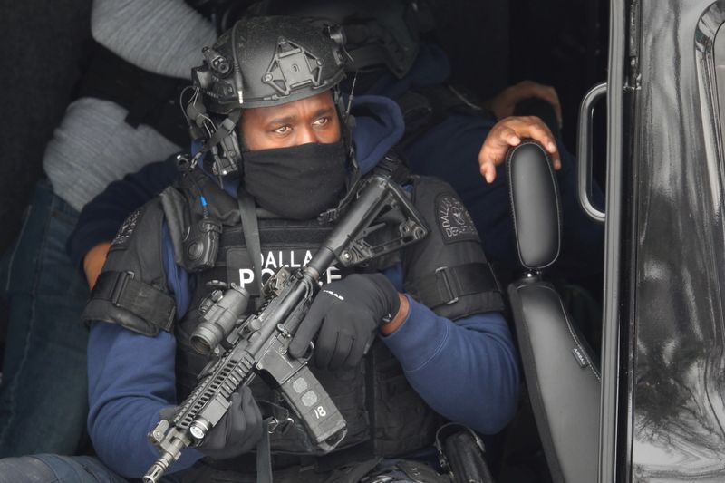 Members of a SWAT team deploy in a residential neighbourhood after two police officers were shot in Dallas, Texas, U.S. February 18, 2021. REUTERS/Brandon Wade