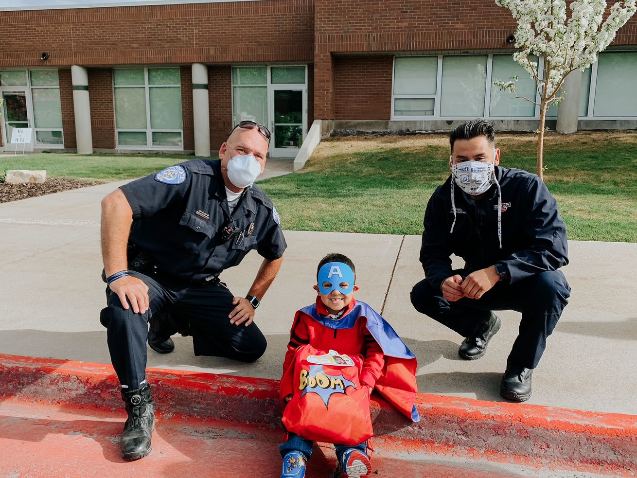 Park City Police Department civilian employee Junior
Enrique Sanchez, right, poses for a photo with nephew Wesley
Morales, center, and Park City officer Trent Jarman, left. 