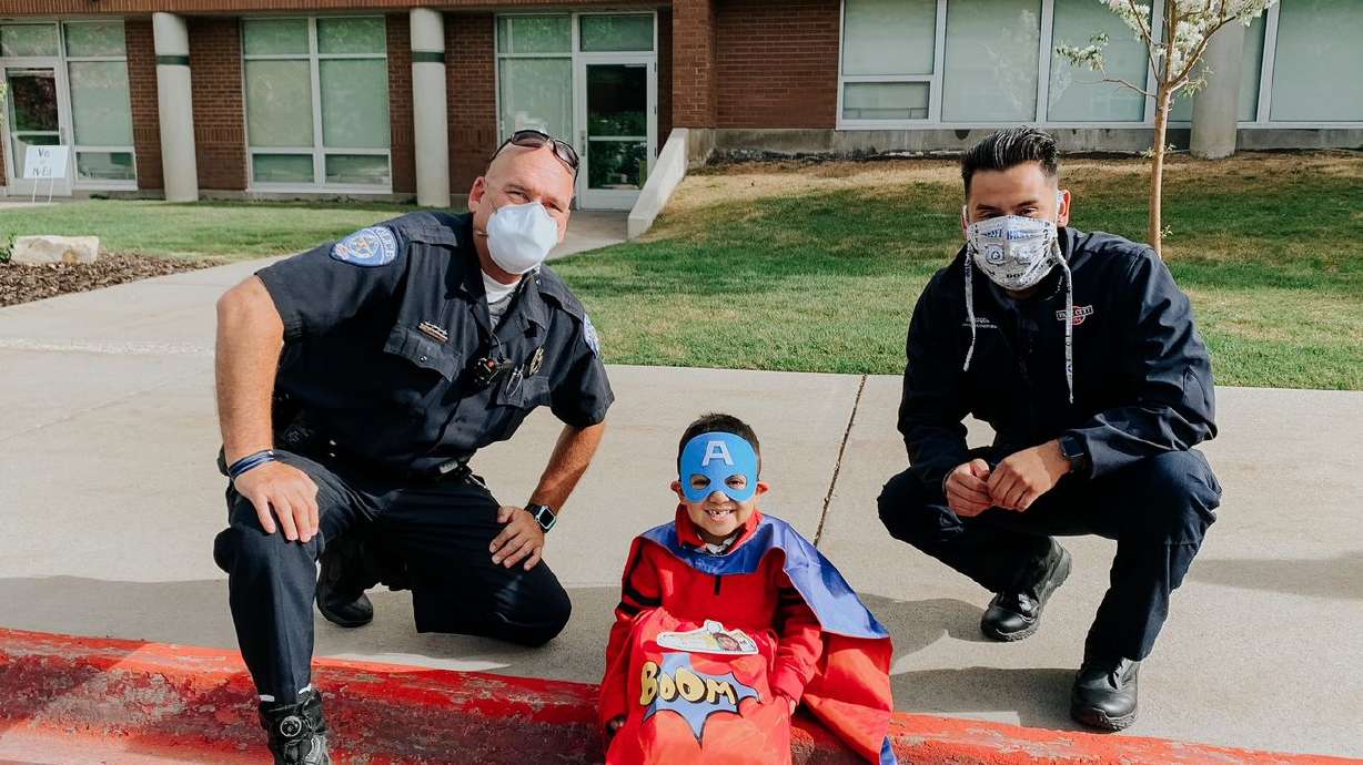 Park City Police Department civilian employee Junior
Enrique Sanchez, right, poses for a photo with nephew Wesley
Morales, center, and Park City officer Trent Jarman, left.