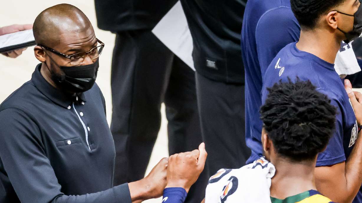 Utah Jazz assistant coach Keyon Dooling, left, fist-bumps guard Donovan Mitchell during a timeout in the game against the Detroit Pistons at Vivint Smart Home Arena in Salt Lake City on Tuesday, Feb. 2, 2021.