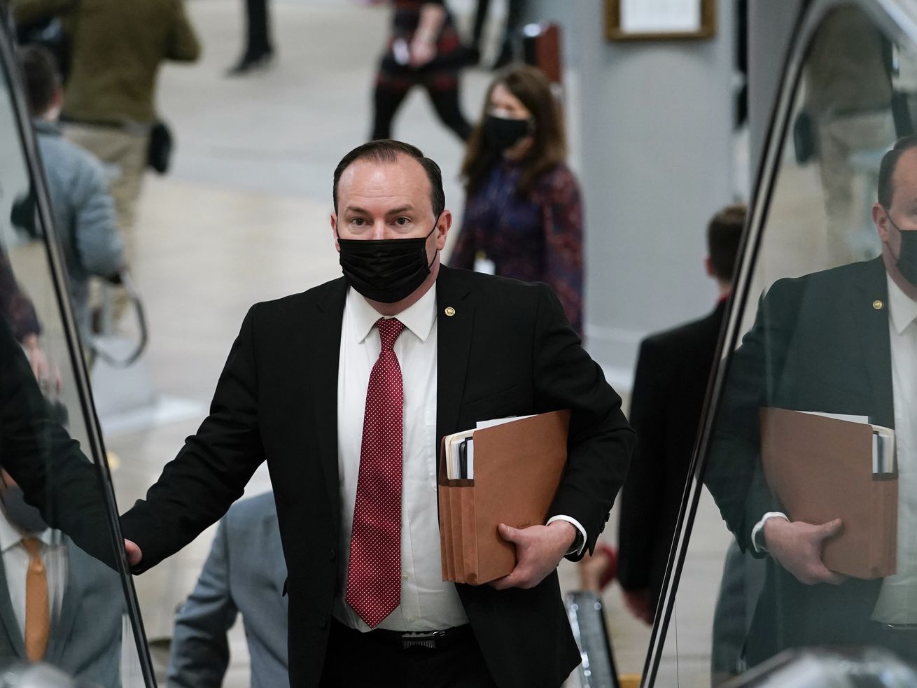 Sen. Mike Lee, R-Utah, walks on Capitol Hill in
Washington, on Feb. 10, 2021, as he heads to the second day of the
second impeachment trial of former President Donald Trump. Lee is
scheduled to attend a fundraiser for his reelection campaign at
Trump’s Mar-a-Lago resort in Florida.