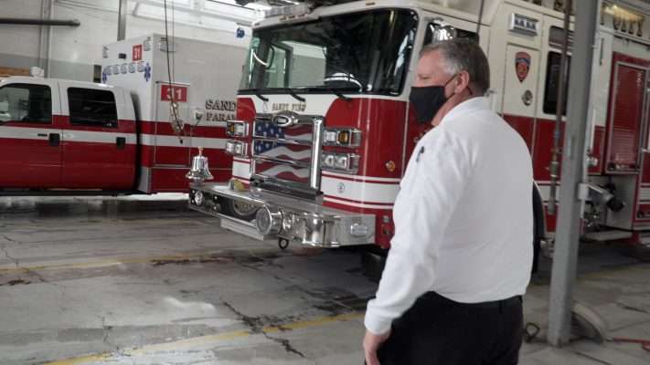 Sandy Fire Chief Bruce Cline walks through the garage at the station.