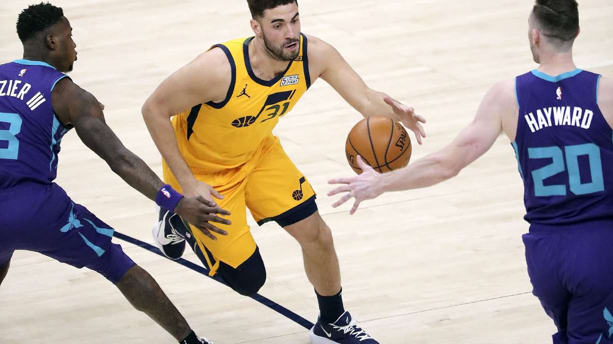 Utah Jazz forward Georges Niang (31) moves between Charlotte Hornets guard Terry Rozier (3) and Charlotte Hornets forward Gordon Hayward (20) during an NBA game at the Vivint Smart Home Arena in Salt Lake City on Monday, Feb. 22, 2021. The Jazz won 132-110.
