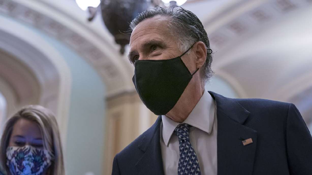 Sen. Mitt Romney, R-Utah, pauses to answer questions
from reporters at the Capitol in Washington on Feb. 13, 2021.
Romney is proposing to raise the minimum wage to $10 an hour and
tie future increases to inflation.