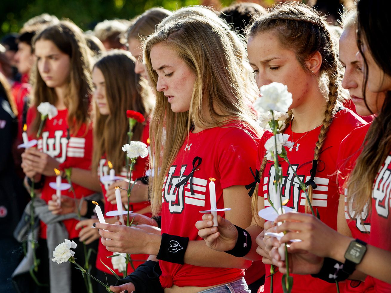 Members of the University of Utah track team attend a
vigil for Lauren McCluskey at the Park Building on Wednesday, Oct.
24, 2018. McCluskey was killed by a man blackmailing her over
intimate photos, which were then shared by a police officer
investigating the case. Utah lawmakers voted to close a loophole
that prevented charges against the police officer.
