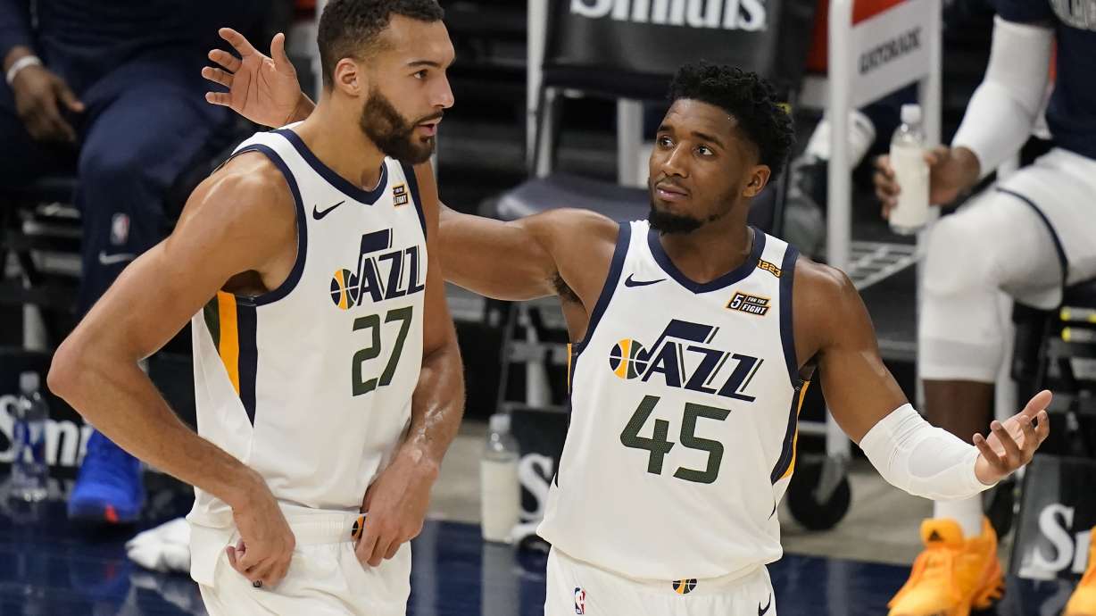 Utah Jazz's Donovan Mitchell (45) and Rudy Gobert (27) walk on the court in the second half during an NBA basketball game against the Milwaukee Bucks Friday, Feb. 12, 2021, in Salt Lake City. (AP Photo/Rick Bowmer)