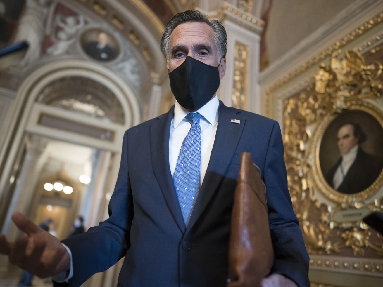 Sen. Mitt Romney, R-Utah, pauses to answer questions
from reporters at the Capitol in Washington, Tuesday, Feb. 23,
2021.