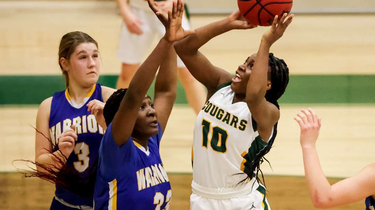 Kearns’ Lanice Hill shoots over Taylorsville’s Aysha Salami in a 6A first round girls basketball game on Tuesday, Feb. 23, 2021.