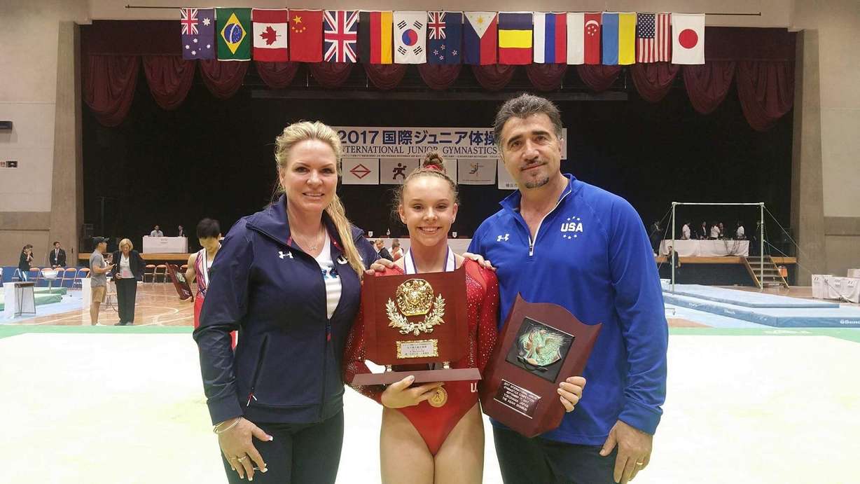 Maile O'Keefe, 17, poses for a photo with her coaches Tammy and Sorin Salcianu in Japan.