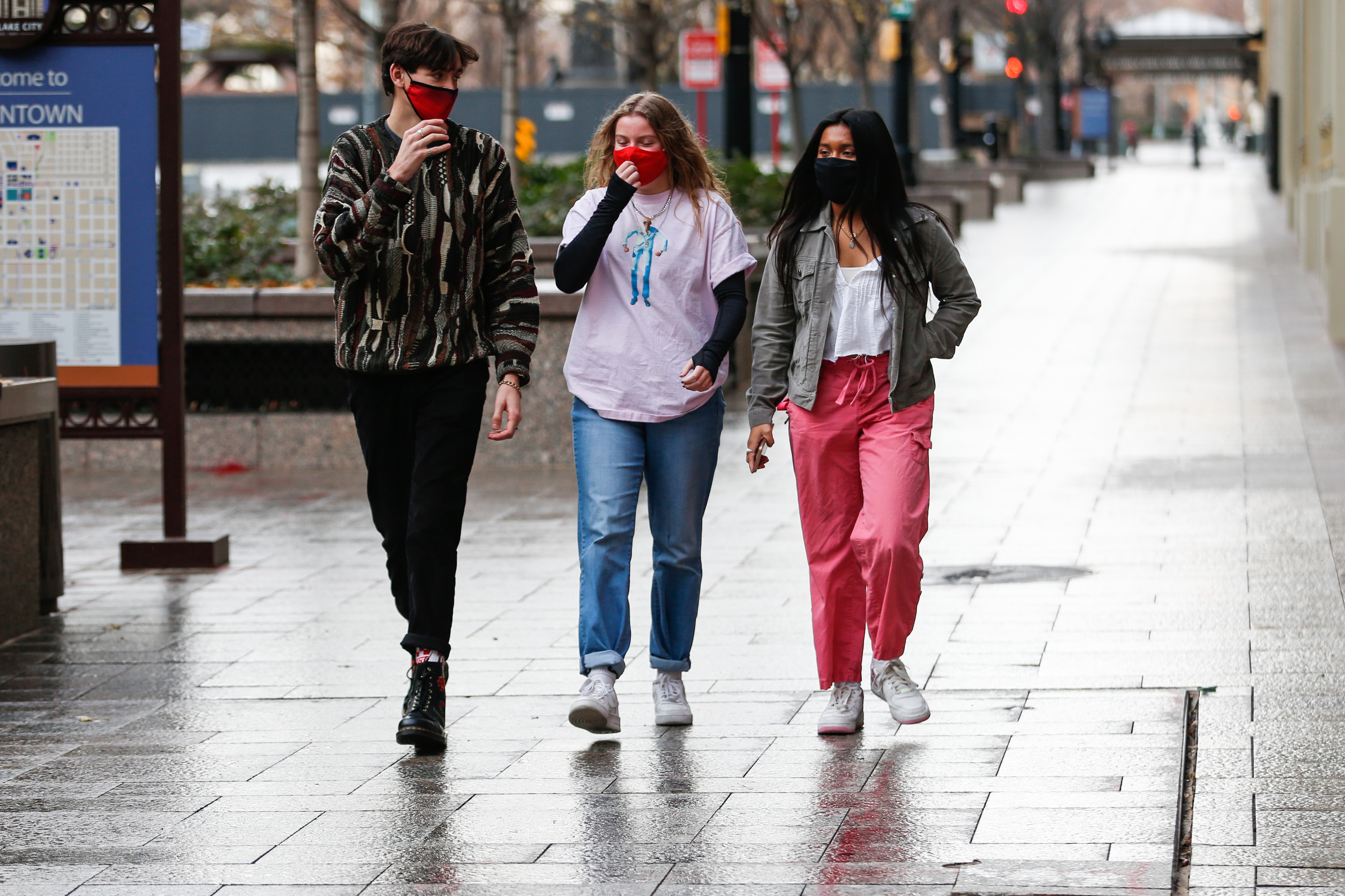 From left, Peter Grinsell, Addi England, and Celeste Dorantes walk along Main Street in Salt Lake City on Monday, Nov. 23, 2020.