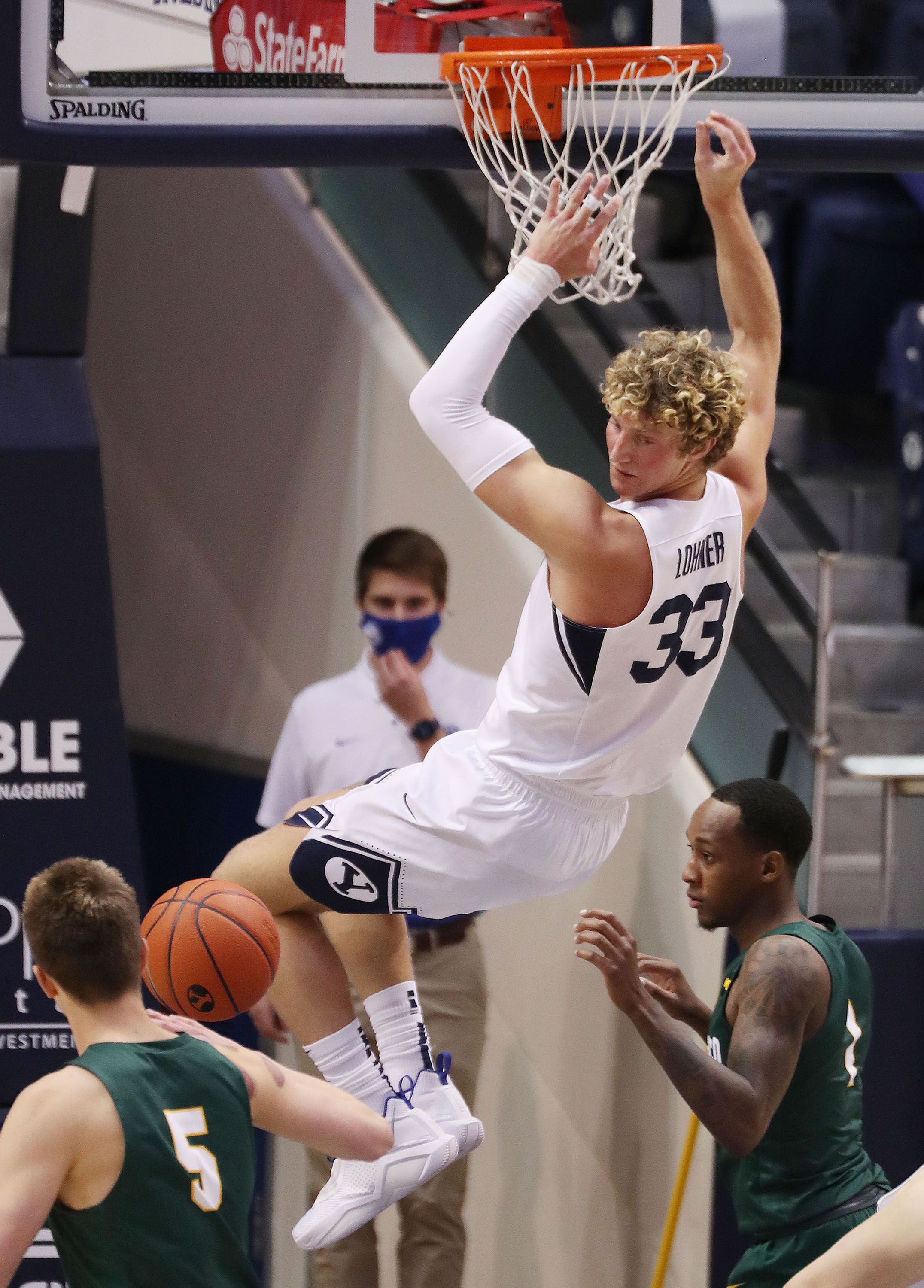 Brigham Young Cougars forward Caleb Lohner (33) dunks over the San Francisco Dons in Provo on Thursday, Feb. 25, 2021.