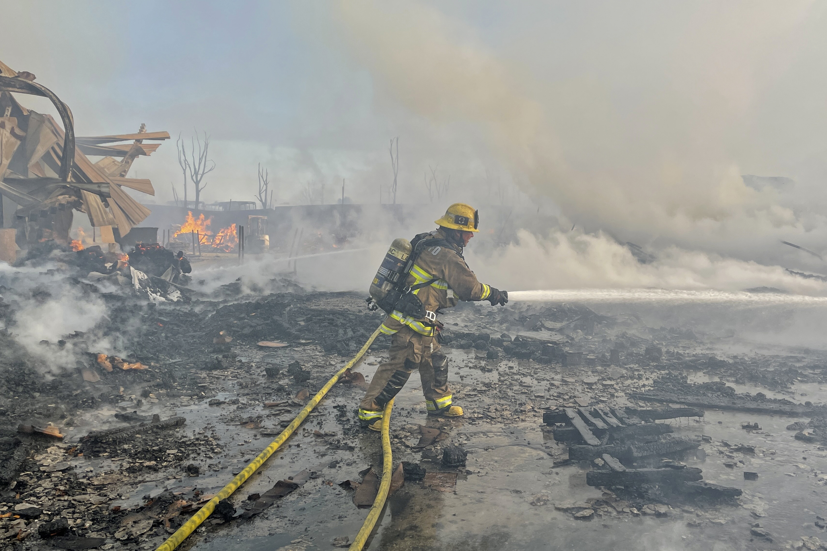 Fire visible across Los Angeles burns commercial yard, buses