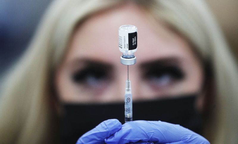 Lia Smith, a registered nurse assistant, prepares a COVID-19 vaccine at the Mountain America Exposition Center in Sandy on Tuesday, Feb. 9, 2021, where those 70 and older are receiving
the vaccination.