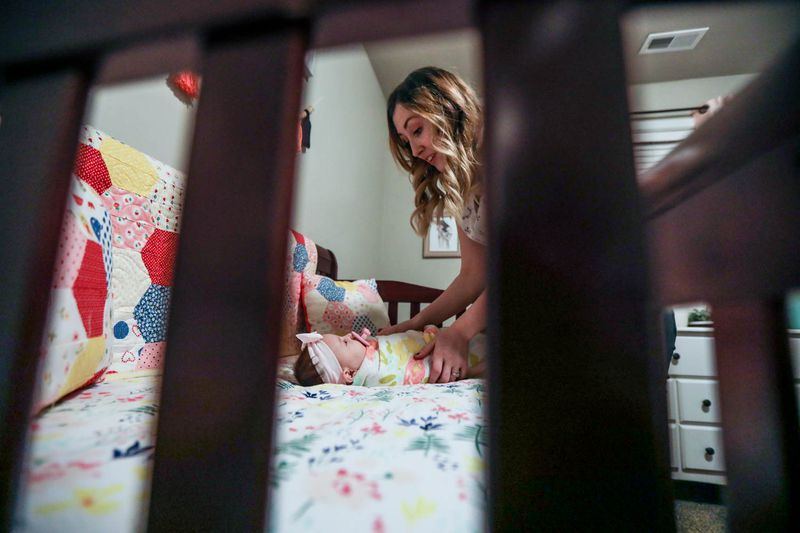 Megan Neil gets daughter Charlotte ready for bed in their home in Vineyard on Monday, Feb. 22, 2021.